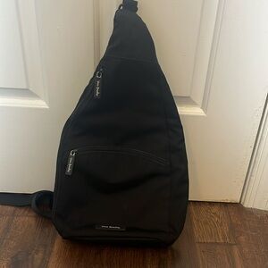 Vera Bradley sling book bag with floral print on inside.